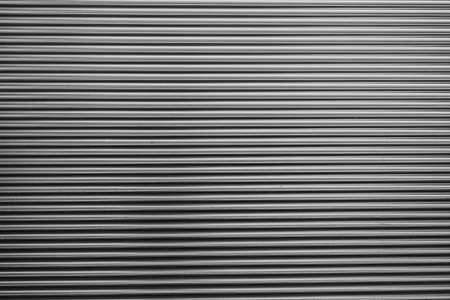 Metal corrugated background with free space for text. Gray wavy grooved metal texture, copy spaceの写真素材