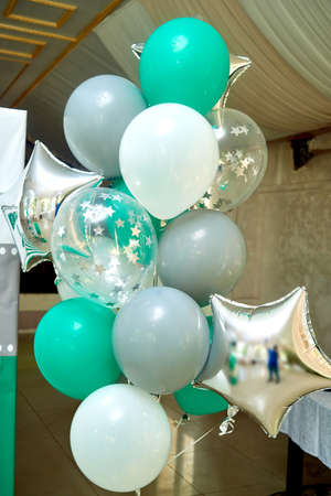 Group of turquoise, gray and white birthday balloons. Pastel party balloons, free space. Love, happiness, valentine, wedding honeymoon concept. Happy holiday flying balloonsの写真素材
