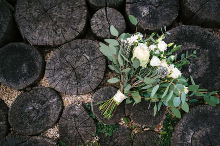 Beautifil lush wedding bouquet of white flowers and greenery on wooden background with place for text. Bridal bouquet, copy spaceの写真素材