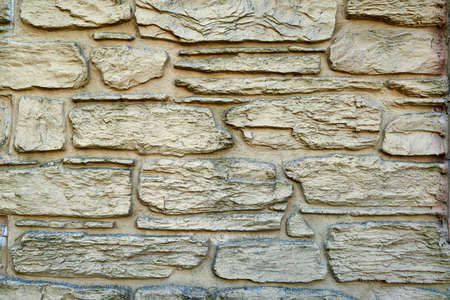 Stone texture background, copy space. Detail of stone abstract background, free space. Decorative uneven cracked stone wall surfaceの写真素材