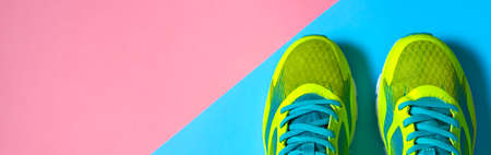Pair of sport shoes on colorful background. New sneakers on pink and blue pastel background, copy space.の写真素材