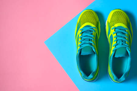 Pair of sport shoes on colorful background. New sneakers on pink and blue pastel background, copy space.の写真素材