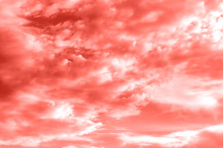 Sky with clouds, copy space. Living Coral background. Color of the year 2019. Nature heaven backgroundの写真素材