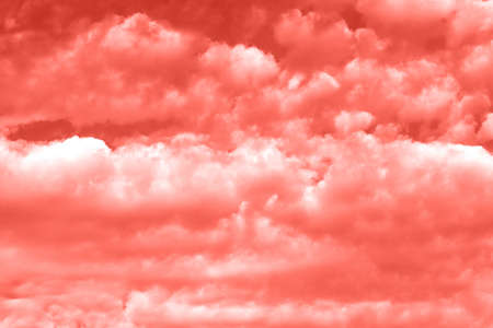 Sky with clouds, copy space. Living Coral background. Color of the year 2019. Nature heaven backgroundの写真素材