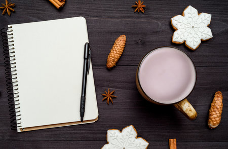 Top view of blank notebook with pen, cup of cocoa and ginger snowflake cookies on wooden background, copy space. Christmas background, free space. Flat lay, above, overheadの写真素材