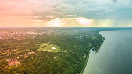 spectacular and very colorful sunset over the golf course in the private residence of Mezhyhiria and the small village of New Petrovtsy .Kyiv, Ukraine - Cityscape Aerial Flightの写真素材