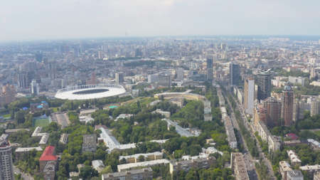 Stadium in a green city, a terrible sky and the suns rays. Kyiv, Ukraine - Cityscape Aerial Flightの写真素材