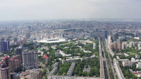 Stadium in a green city, a terrible sky and the suns rays. Kyiv, Ukraine - Cityscape Aerial Flightの写真素材