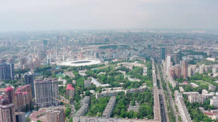 Stadium in a green city, a terrible sky and the suns rays. Kyiv, Ukraine - Cityscape Aerial Flightの写真素材