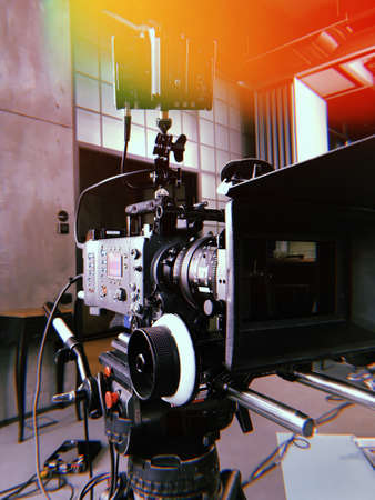 movie camera on the tripod, interior setの写真素材