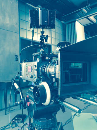movie camera on the tripod, interior setの写真素材