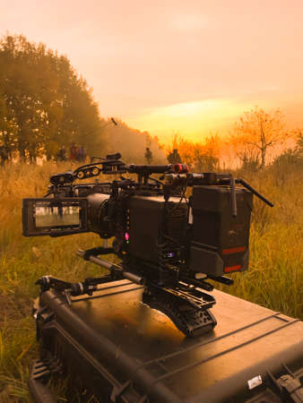 shooting a film at dawn, one camera in standby mode, the second group in force to shoot in the backgroundの写真素材