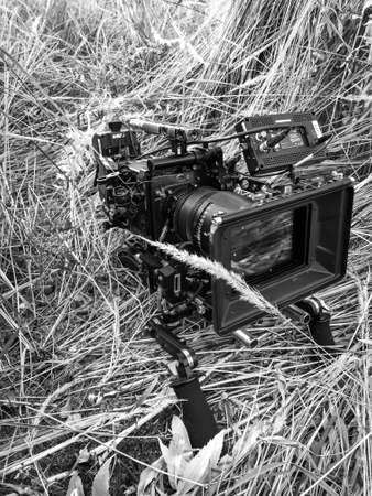 the suns rays shine through a movie camera on a field