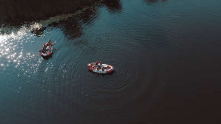 water rescue operation, a man overboard and a rescue service rescues him. The view from the helicopterの写真素材