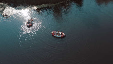 water rescue operation, a man overboard and a rescue service rescues him. The view from the helicopterの写真素材