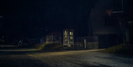 night telephone booth. mystical and mysterious street phone. dangerous place on an empty streetの写真素材