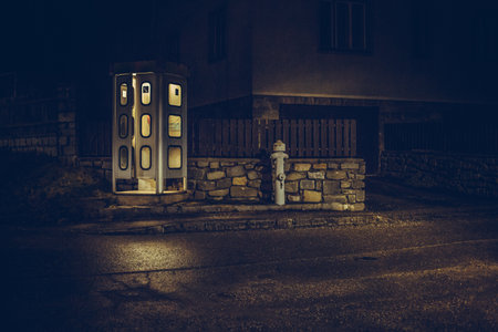 night telephone booth. mystical and mysterious street phone. dangerous place on an empty streetの写真素材