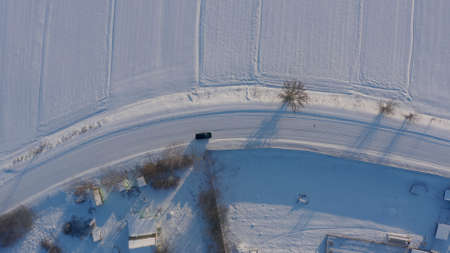 winter road top view. long turn a smooth turn on a slippery snowy road. dangerous road icy. aerial...