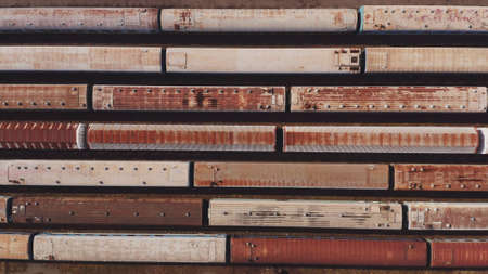 Railway hub showing passenger old crusty trains on tracks next to each other top down view drone moving slowly showing railway tracks positioned parallel. Old Railway Carriages and Wagons 4kの写真素材