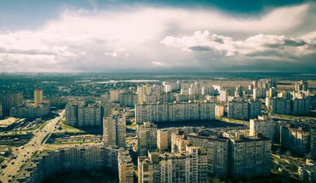 urban dormitory area in eastern europe. roundabout in the city. calm ordinary life and storm clouds approaching in the background. the cyclone is approaching the city .の写真素材