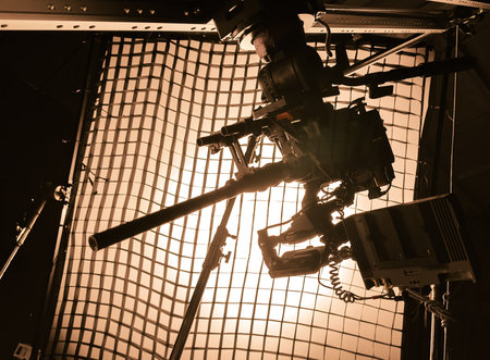 movie camera with macro lens on the slider in the backlight from the frame with grid, the rays of...
