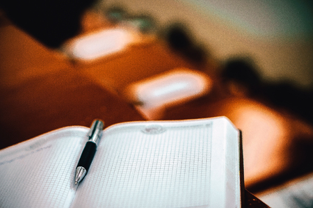 The pen rests on a notebook.の写真素材