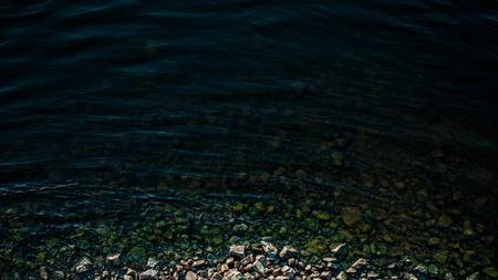 River water on the shore. Waves on the waterの写真素材