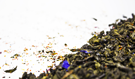 Green tea with flower petals. White background.の写真素材