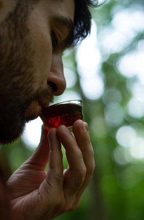 Close up of bearded man drinking shu pu-erh tea in forestの写真素材