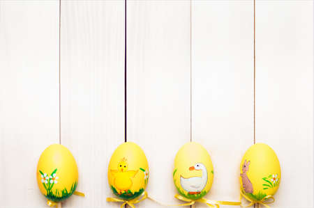 Easter eggs. Easter eggs on a stick on a light boards. Funny eggs. Easter Bunny. Space for text.