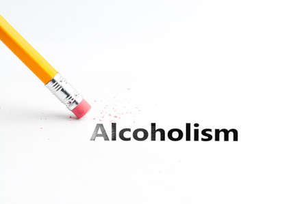Closeup of pencil eraser and black alcoholism text. Pencil with eraser. Yellow pencil.の写真素材