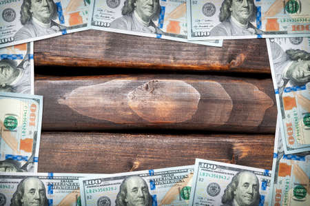 Denominations of American hundred dollar bills on a background of old boards. American dollar....