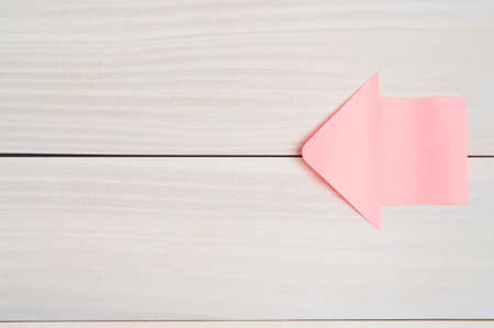 Stickers in the shape of a arrow on a wooden background.Sticker arrow.Background from boards.の写真素材