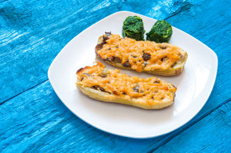 Stuffed zucchini. Zucchini baked with mushrooms and cheese, side dish of spinach pyramids. Spinach.の写真素材