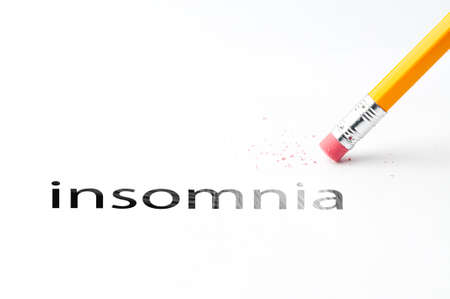 Closeup of pencil eraser and black insomnia text. Insomnia. Pencil with eraser.の写真素材