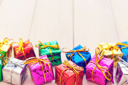 Boxes with gifts on a light wooden boards. White notepad. Happy new year. Space for text. Old background. New Year background.の写真素材