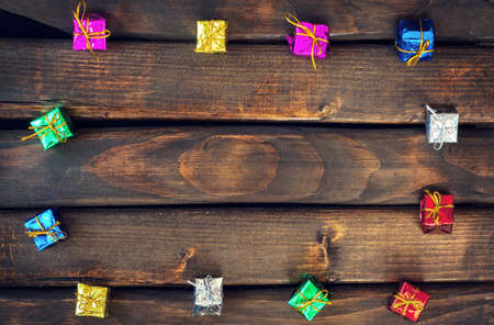 Boxes with gifts on a dark wooden boards. Happy new year. Space for text. Old background. New Year background.の写真素材