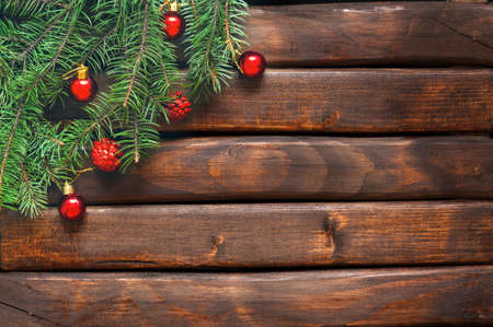 Branches of a Christmas tree on old boards. Christmas background. New Year background. Xmax background. Toning antique.の写真素材