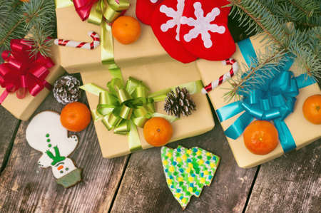 Christmas gifts boxes on the old dark boards. Christmas background. Christmas decorations. New Year...