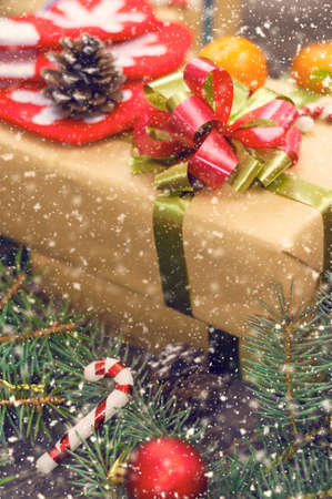 Christmas tree branches on old boards. Christmas background. Christmas Socks. Christmas decorations. New Year background. Xmax background. Toned image. Falling Snow.の写真素材