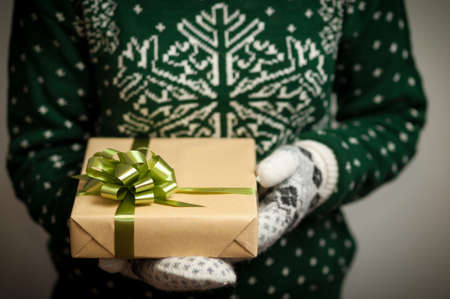 Christmas gifts. Knitted mittens. Knitted dress. Box with gifts. Present.の写真素材