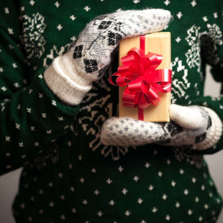 Christmas gifts. Knitted mittens. Knitted dress. Box with gifts. Present.の写真素材