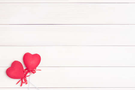 Two red hearts on sticks on a background of wood.Hearts on sticks.Space for text.Valentine's Day.Valentine day.Eighth of March.International Women's Day.Vintage processing.の写真素材