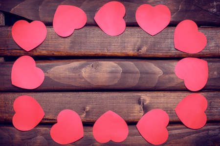 Red heart stickers on a dark wooden background.Background Valentines Day.Valentine's Day.Valentines Day.Valentines day ideas.Valentines day cards.International women's day.Women's day.March 8.の写真素材