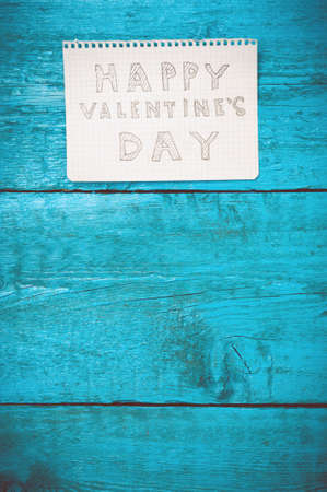 Valentine day. Note Happy Valentine's Day on the blue boards. Valentine's Day. Space for text. Toned image.の写真素材