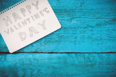 Valentine day. Note Happy Valentine's Day on the blue boards. Valentine's Day. Space for text. Toned image.の写真素材