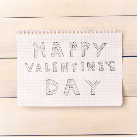 Valentine day. Note Happy Valentine's Day on the light boards. Light wood. Valentine's Day. Space for text. Toned image.の写真素材