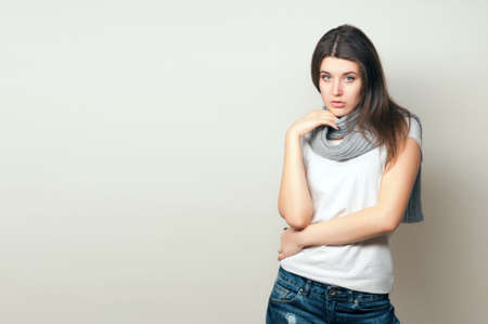 Beautiful young woman. Young girl. Girl in jeans and a gray scarf. Beauty portrait.  Girl portrait...