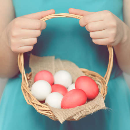 Easter Egg. Girl holding a basket with Easter eggs. Easter eggs lying in a basket. Easter ideas....