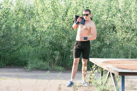 Strong young athlete. Strong young athlete is engaged in on an abandoned sports field. Athlete Outdoors. Toned image.の写真素材